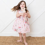 Short-sleeve toddler dress with a small scattered ditzy floral print on a light background