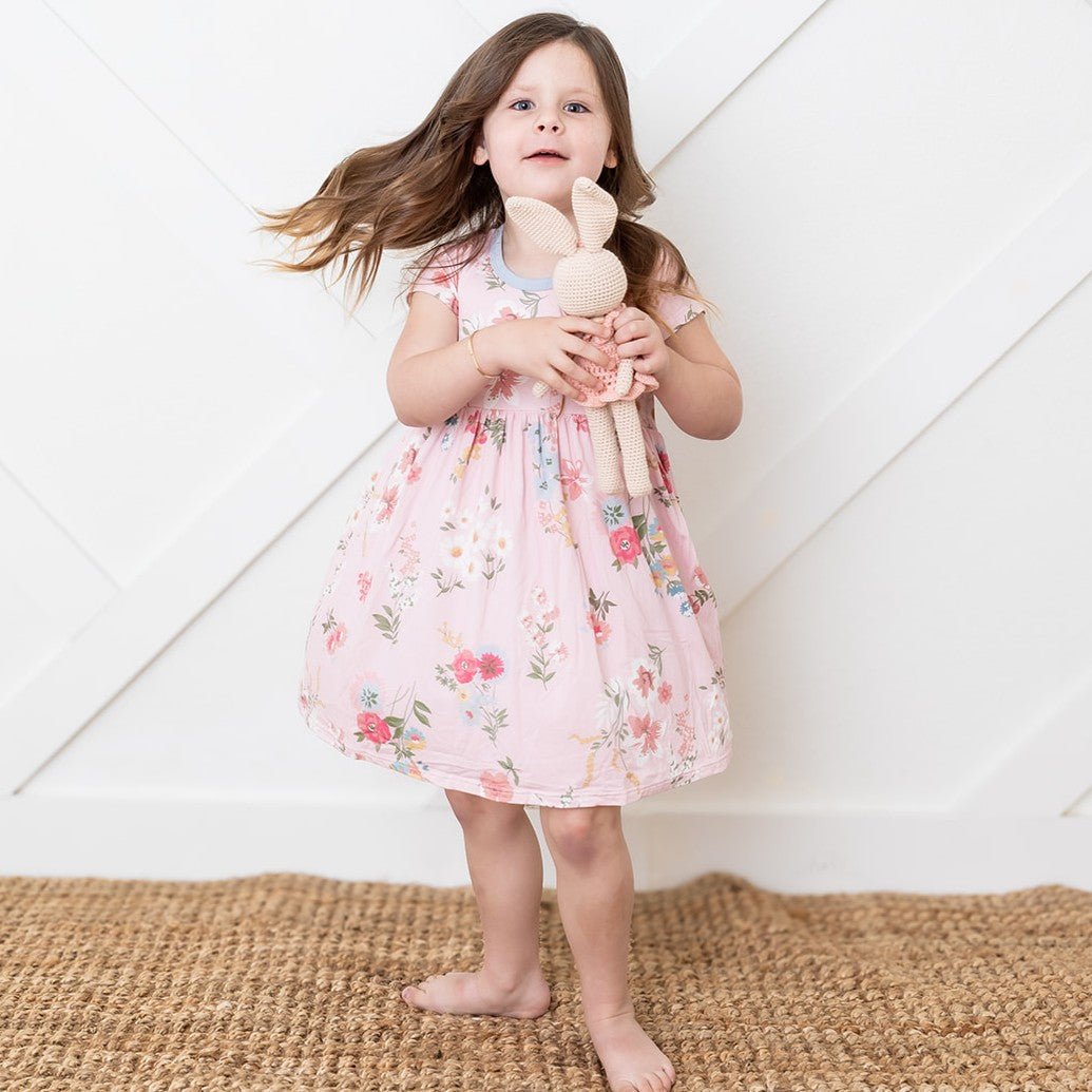 Short-sleeve toddler dress with a small scattered ditzy floral print on a light background