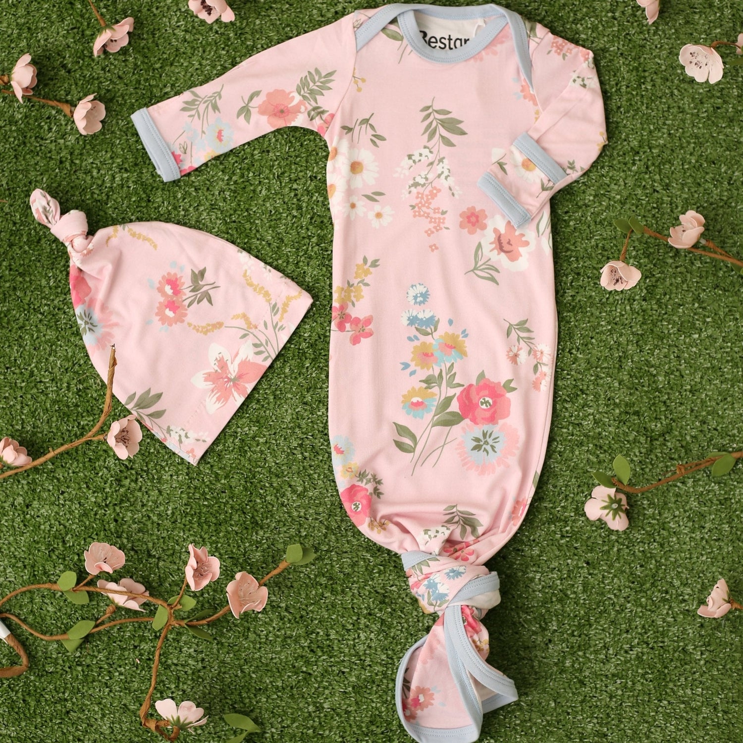 Baby gown and matching hat in a pink ditzy floral print with fold-over mitten cuffs and a knotted bottom