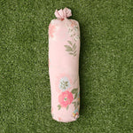 Baby swaddle blanket in a pink ditzy floral print, spread flat to show the small rose pattern.