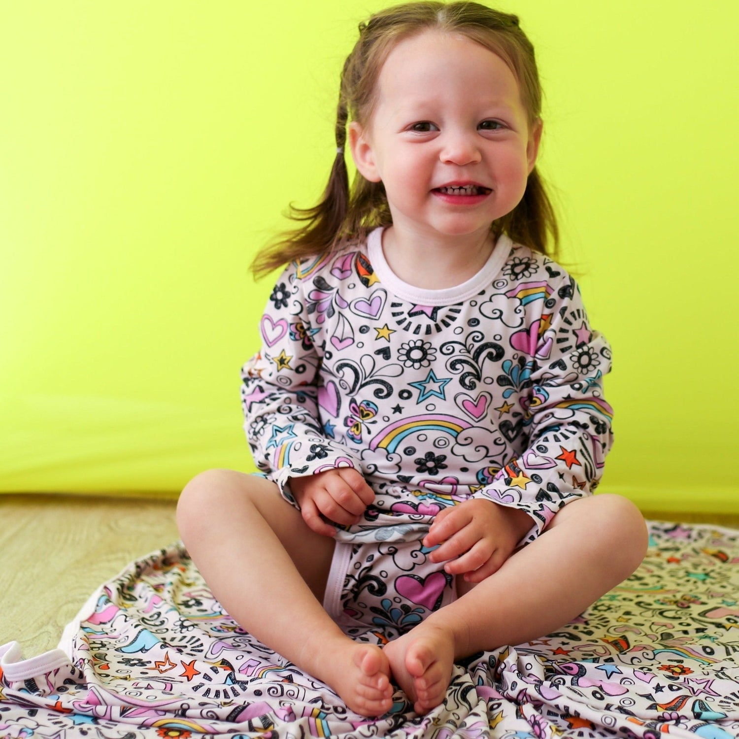Doodle Days bodysuit dress with long sleeves and a hand-drawn doodle print, shown in pink tones.