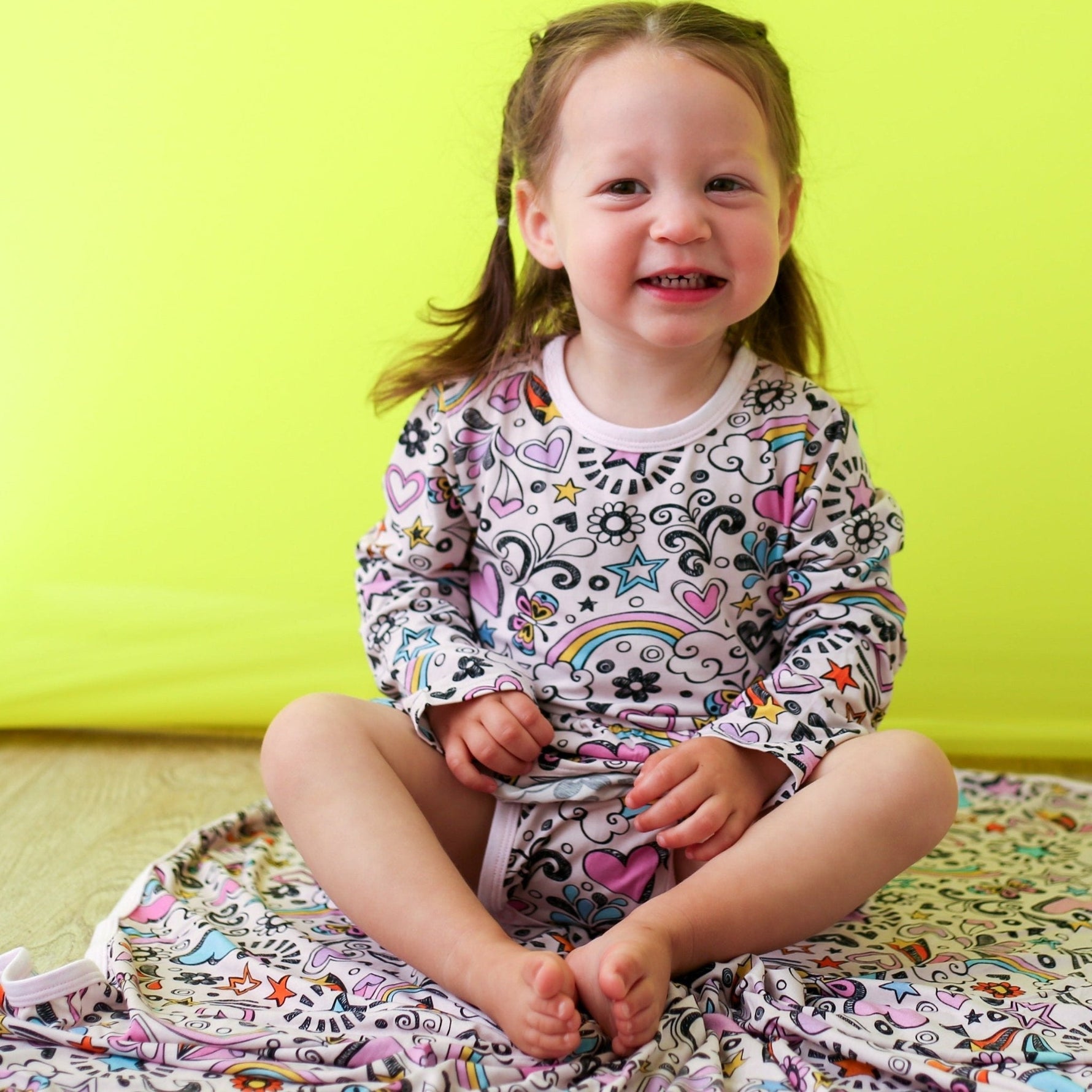 Doodle Days bodysuit dress with long sleeves and a hand-drawn doodle print, shown in pink tones.