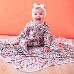 Baby footie pajamas in a playful doodle print with a full-length zipper.