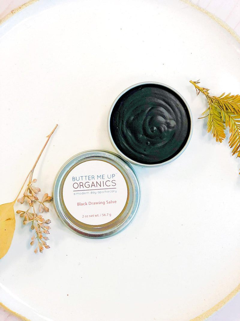 Organic Black Drawing Salve in a jar with natural ingredients; skincare for bee stings, rashes, and skin ailments.