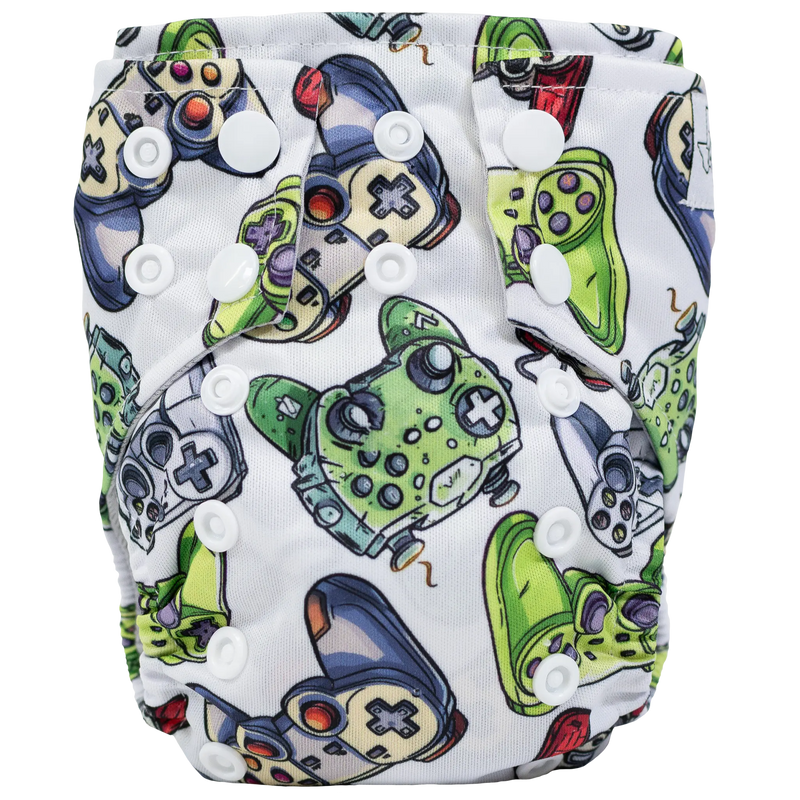 Tiny Tushies Newborn AIO Cloth Diaper with colorful printed design, adjustable snaps, and pocket opening for extra absorbency.