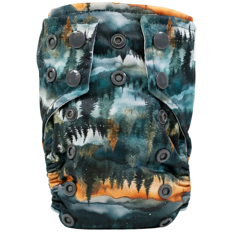 Tiny Tushies Newborn AIO cloth diaper with forest print and adjustable snaps.