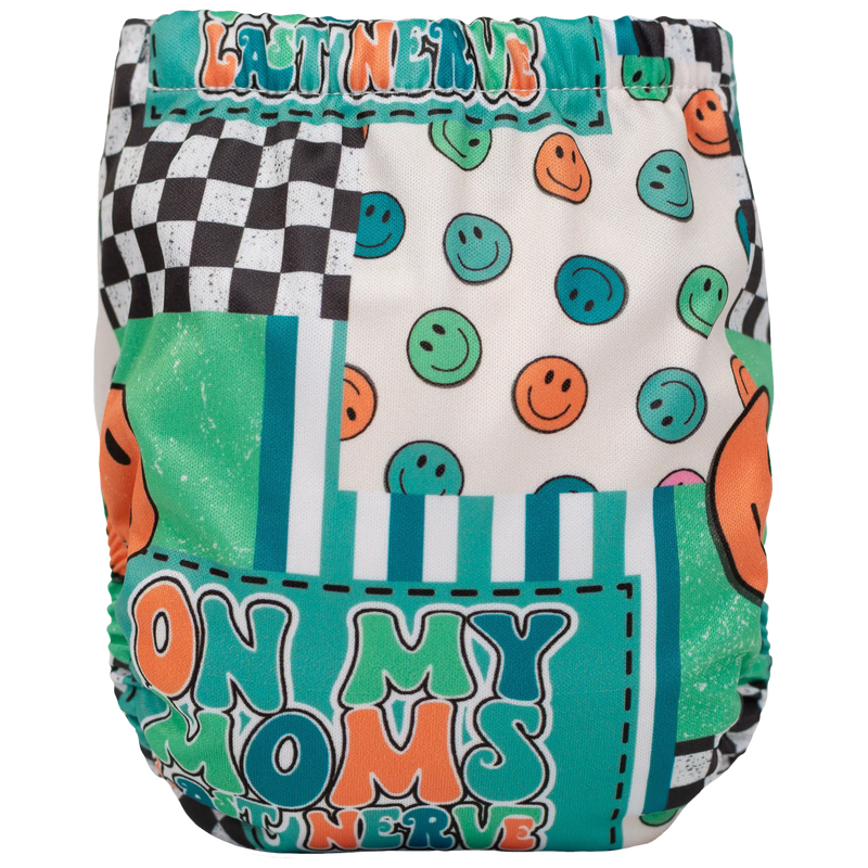 Tiny Tushies Newborn AIO Cloth Diaper with colorful print and secure closure snaps.