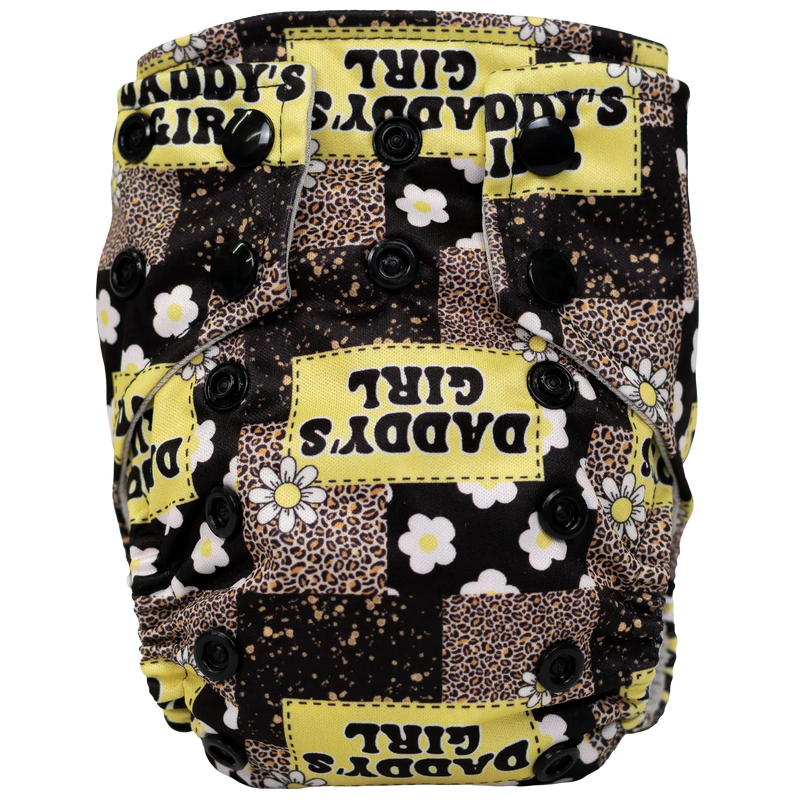 Tiny Tushies Newborn AIO Cloth Diaper with animal and floral print design, featuring snaps for adjustable fit and secure closure.