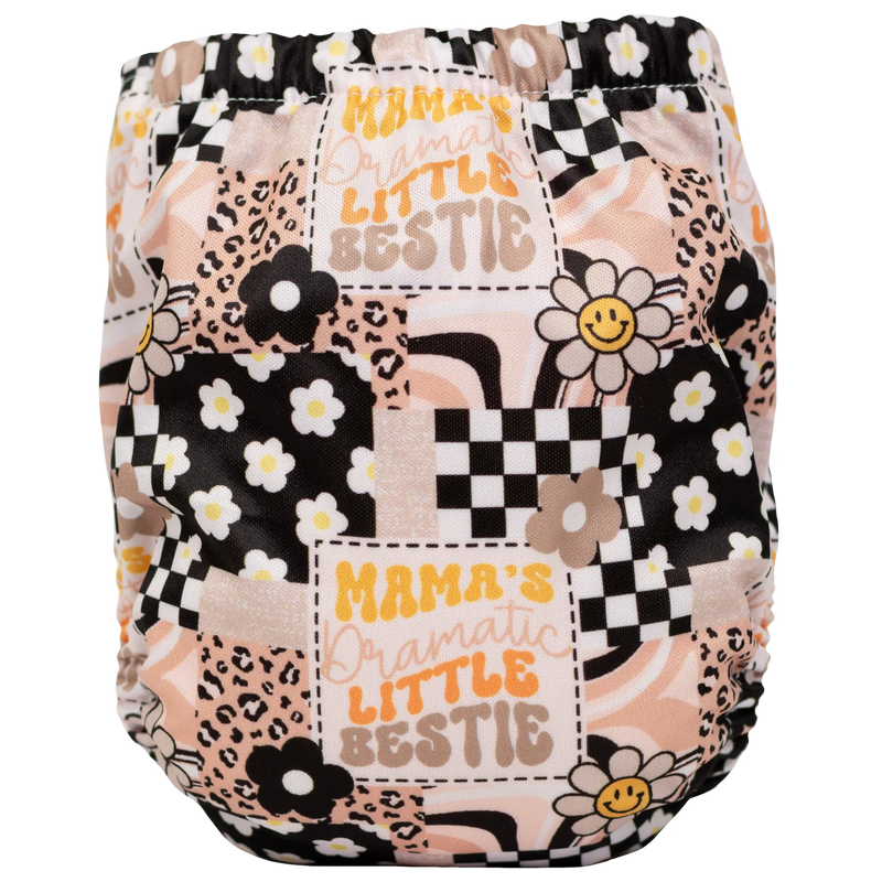 Tiny Tushies Newborn AIO cloth diaper with colorful pattern and floral design.