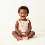 Bubble romper in pink Easter Parade print with flutter sleeves and snap closures along the legs