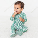 Baby footie pajamas in a green and white checkered pattern with a full-length front zipper and footed legs.
