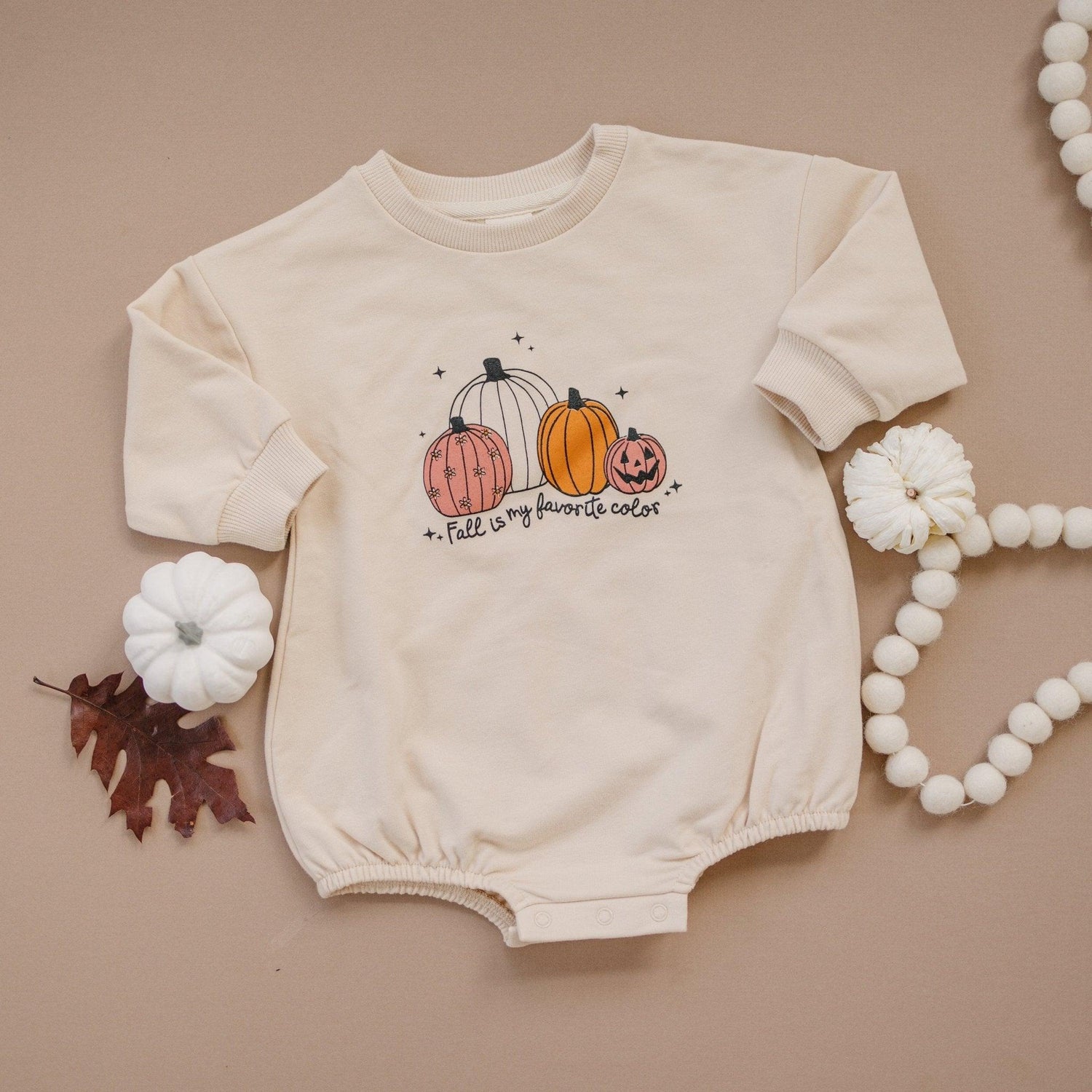 Oversized sweatshirt romper with "Fall Is My Favorite Color" graphic and snaps at the crotch.