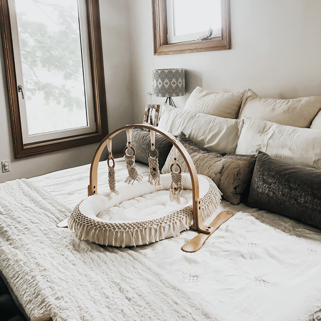 Modern Nursery Natural Play Gym, sustainable wood infant activity center.