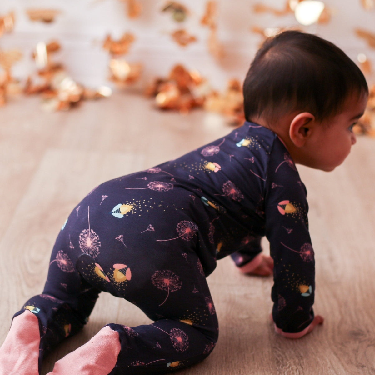 Footie pajamas with a fireflies print, full-length zipper, and covered feet