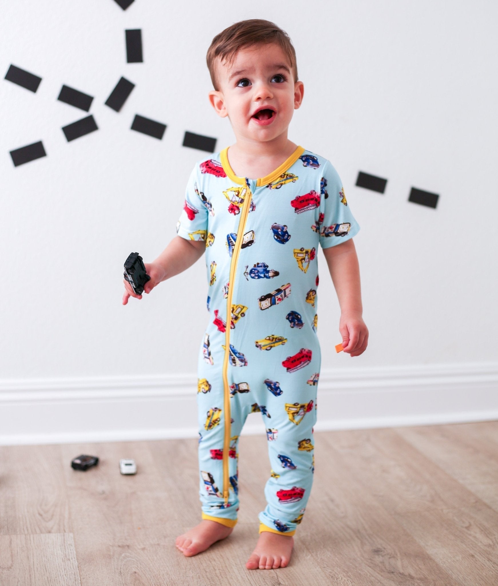 Short sleeve baby coverall with front dual zipper and cuffed ankles in a first responder print