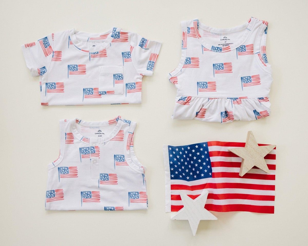 Baby wearing Little Joy Co bamboo flag print pocket tee and matching shorts set