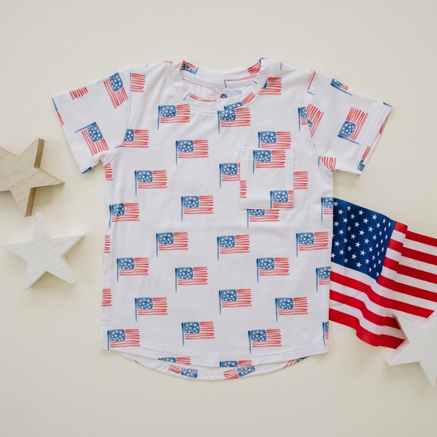 Baby wearing Little Joy Co bamboo flag print pocket tee and matching shorts set