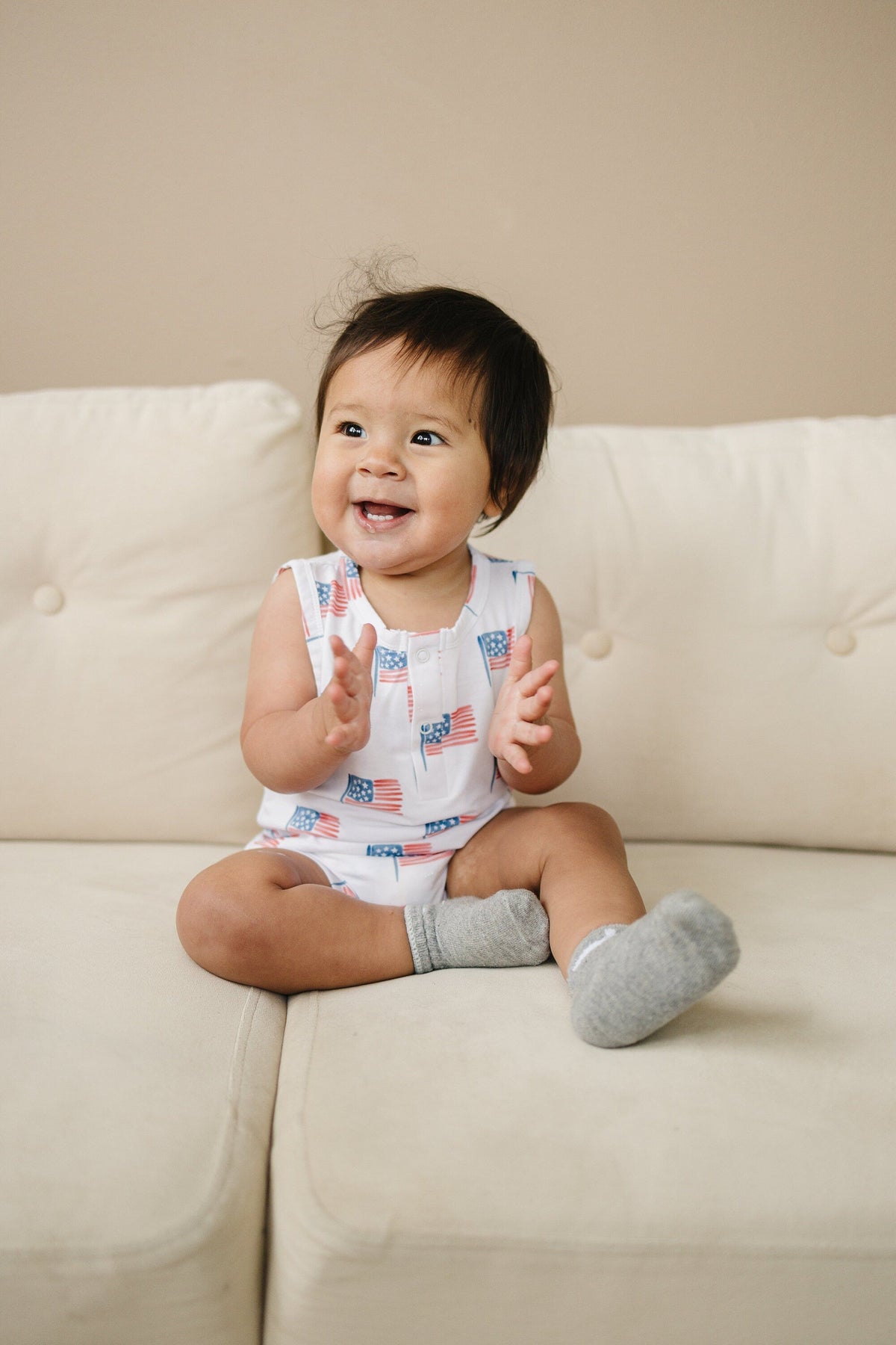 Little Joy Co. baby in a soft bamboo sleeveless romper, perfect for comfortable play and sleep.