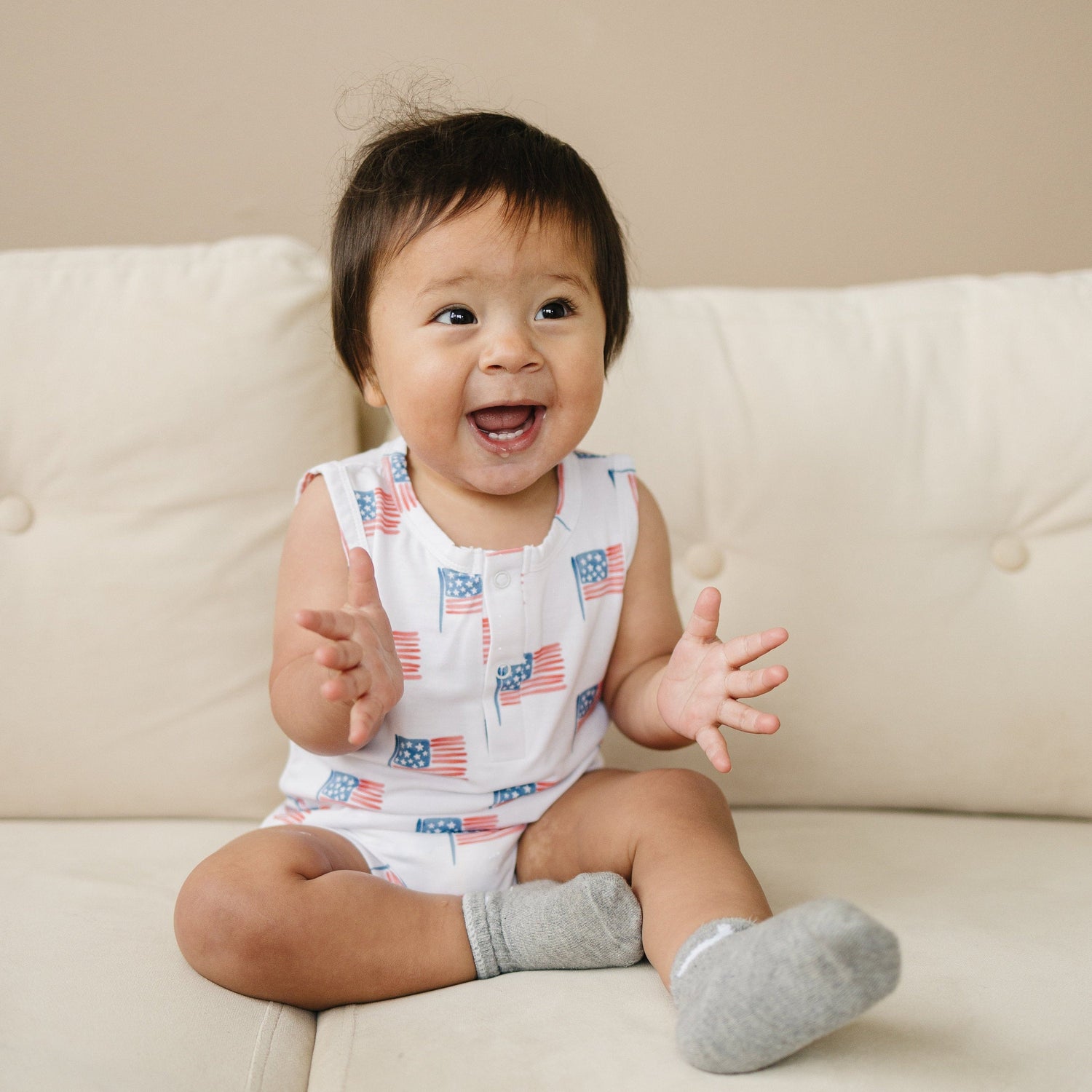 Little Joy Co. baby in a soft bamboo sleeveless romper, perfect for comfortable play and sleep.