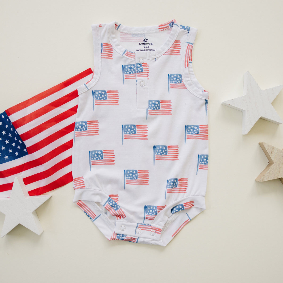 Little Joy Co. baby in a soft bamboo sleeveless romper, perfect for comfortable play and sleep.