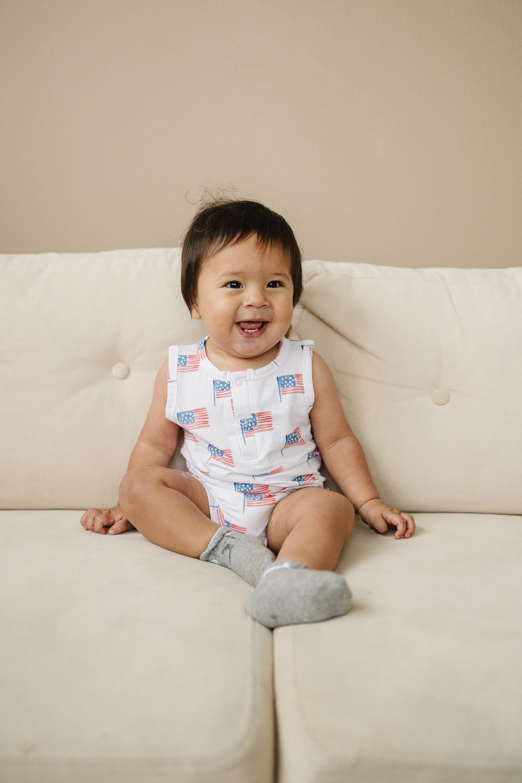 Little Joy Co. baby in a soft bamboo sleeveless romper, perfect for comfortable play and sleep.