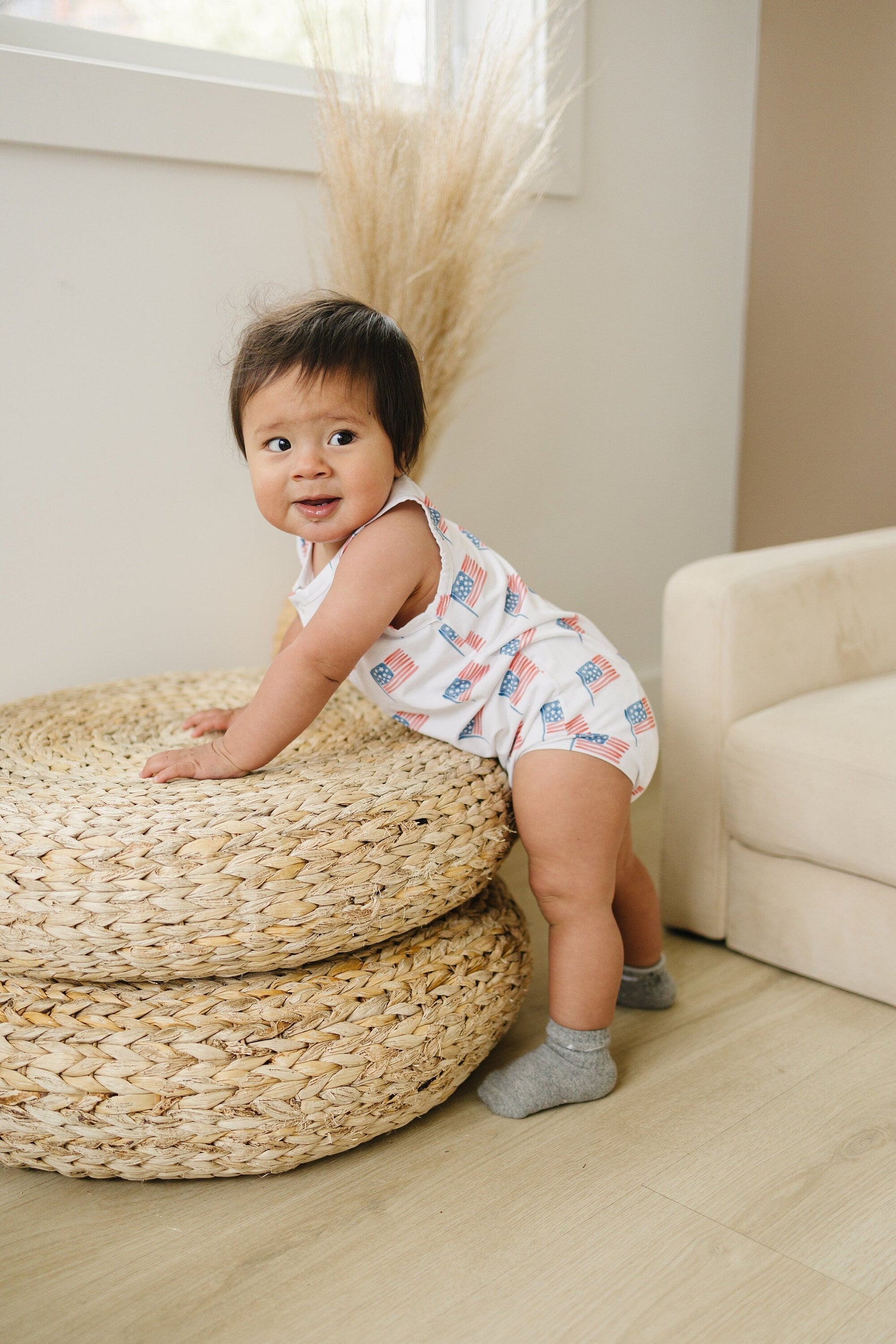 Little Joy Co. baby in a soft bamboo sleeveless romper, perfect for comfortable play and sleep.