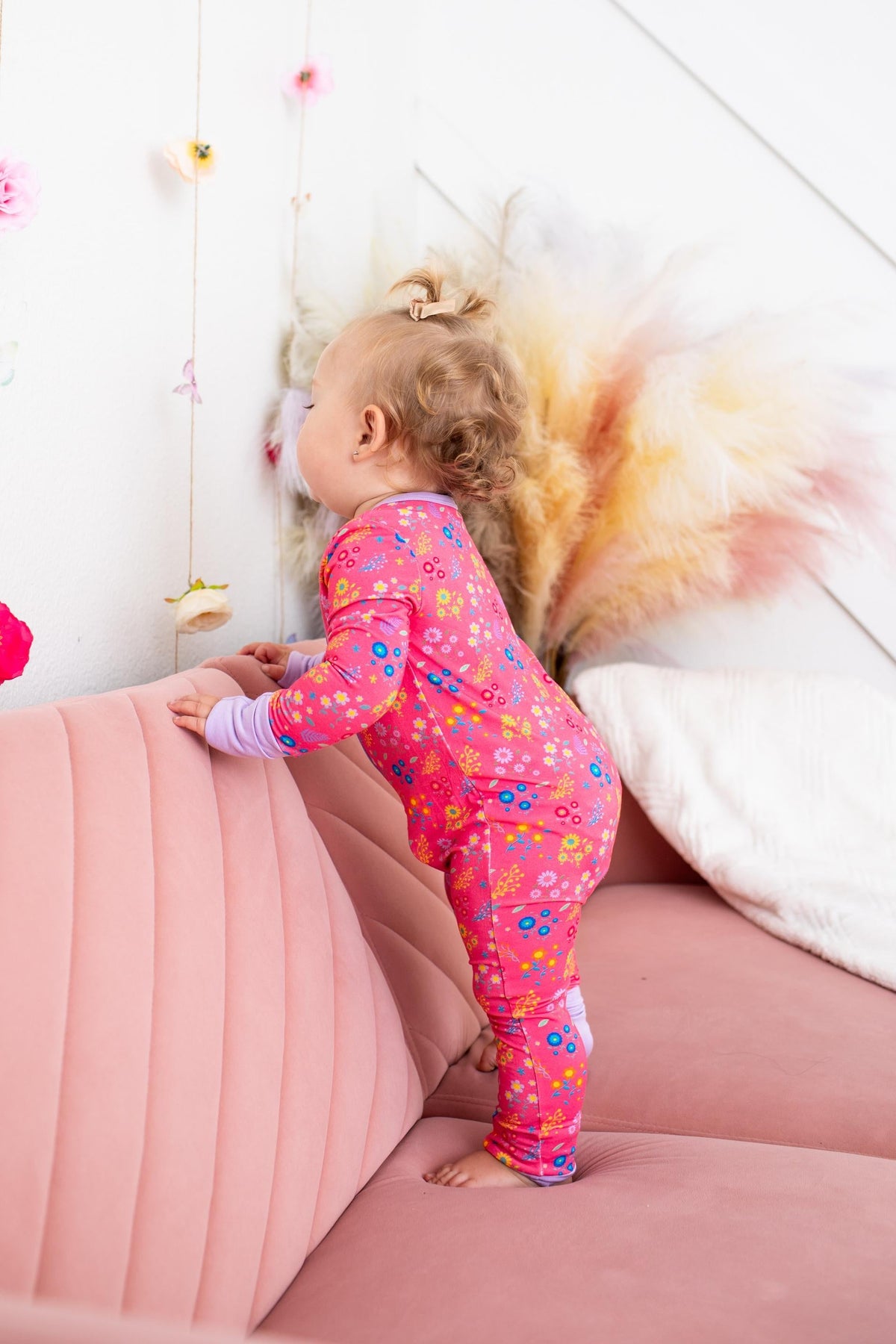 Baby convertible coverall in a flower confetti print with full-length two-way zipper and convertible feet