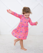 Long sleeve toddler dress in soft bamboo fabric with a scattered flower confetti print and twirl skirt