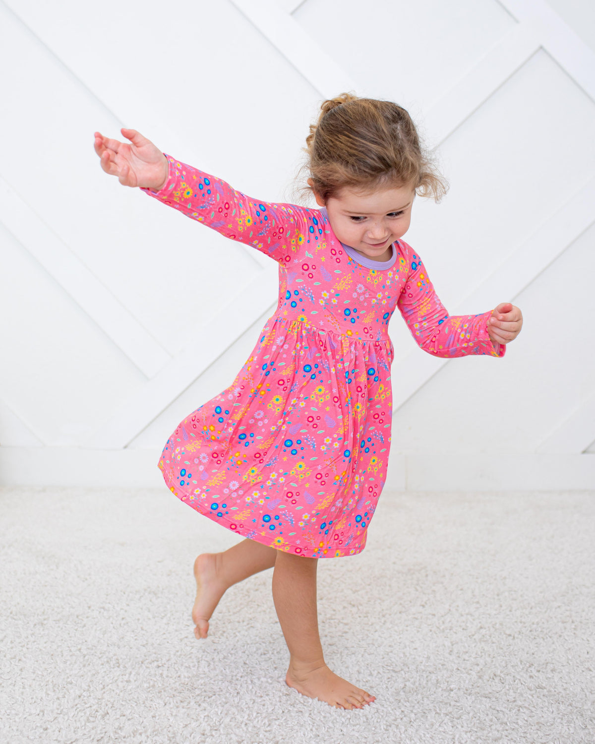 Long sleeve toddler dress in soft bamboo fabric with a scattered flower confetti print and twirl skirt