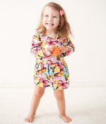 Flutter Dreams bodysuit dress with long sleeves in a pink flutter pattern on a child model