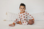 Two-piece baby pajama set with football print, long sleeve top and matching pants