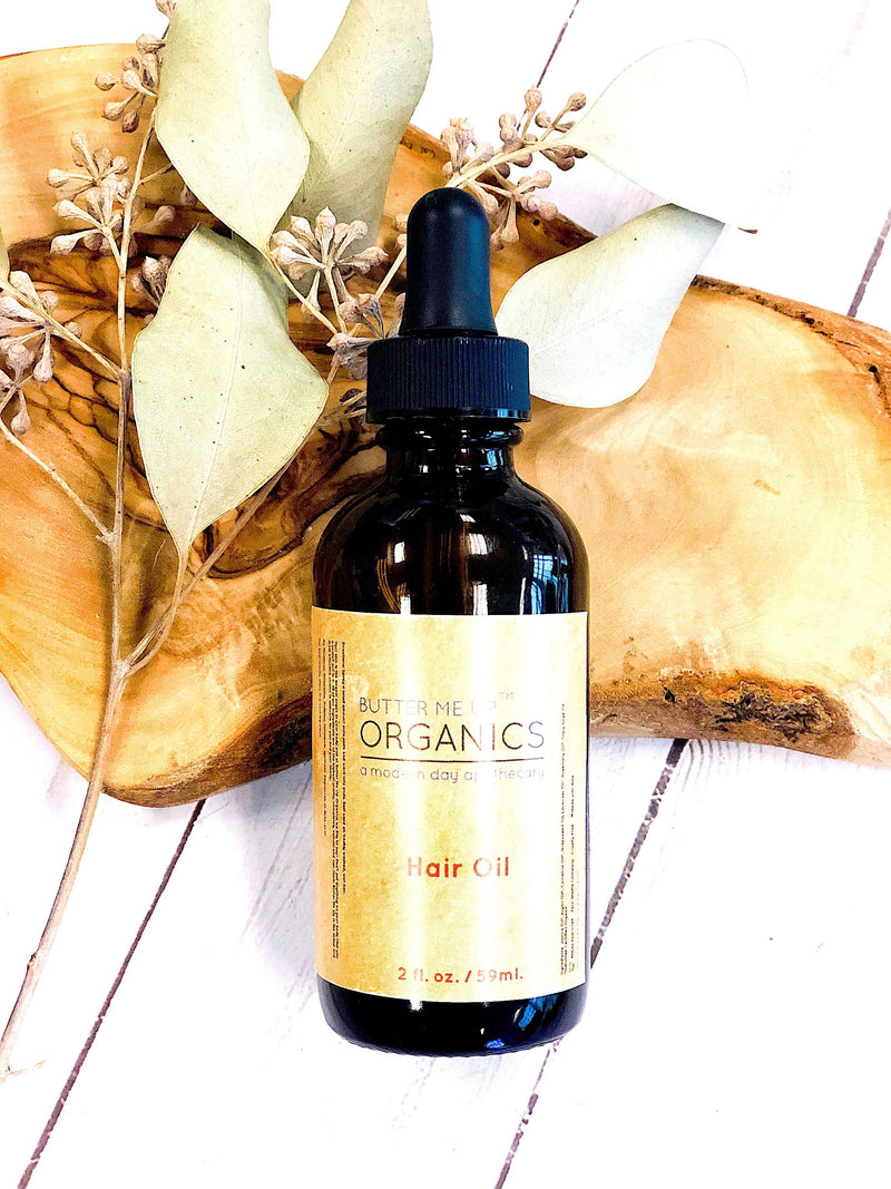 Organic Hair Oil in 2oz glass bottle with natural ingredients and eco-friendly packaging.