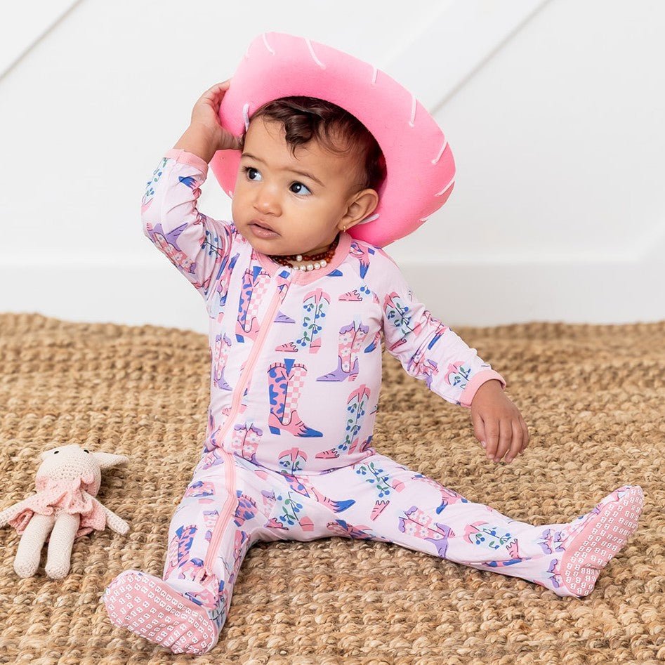 Baby footie pajamas with an all-over western cowgirl boot print and a full-length front zipper.
