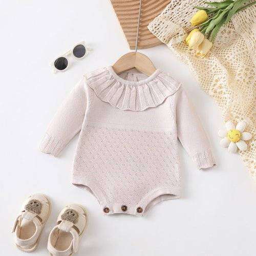 Girl long sleeve onesie with scalloped neck design, shown with matching accessories.