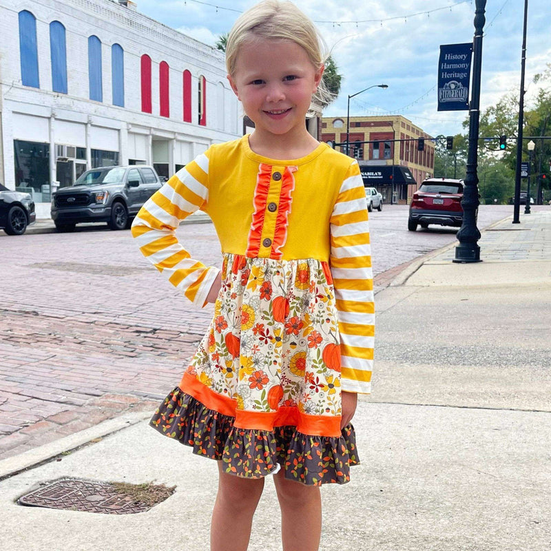 Girls cotton fall dress with autumn floral print, mustard striped sleeves, and ruffle trim.