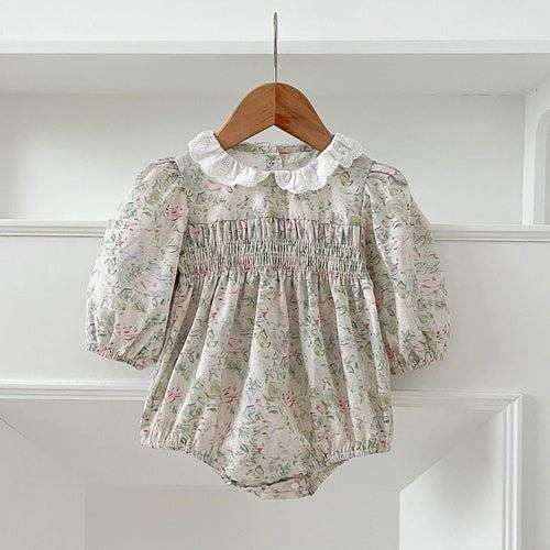 Girls long sleeves floral dress with gathered design and lace collar on hanger.