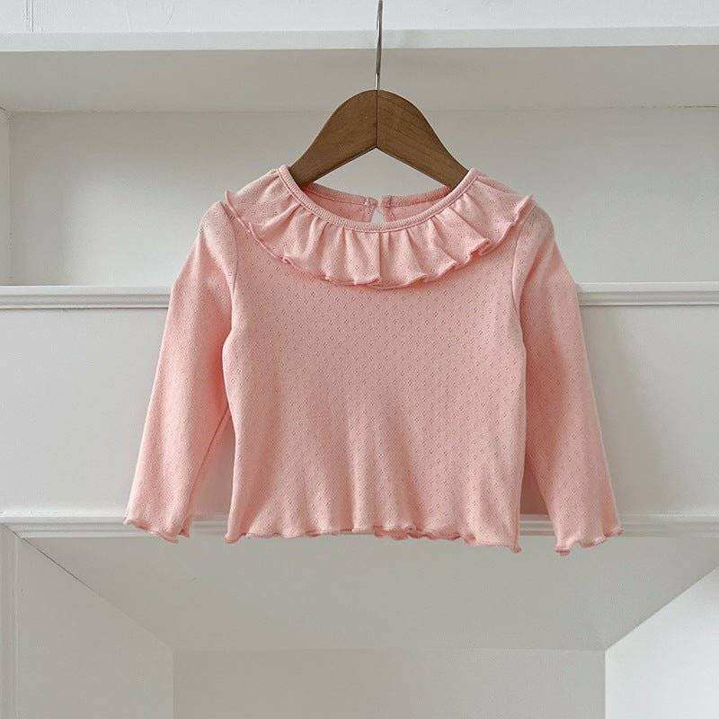 Girls' soft comfortable long top in light pink with ruffled collar on hanger.