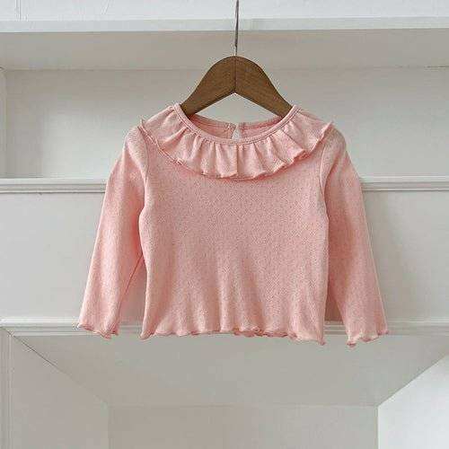 Girls soft comfortable simple long top in pink on a hanger.