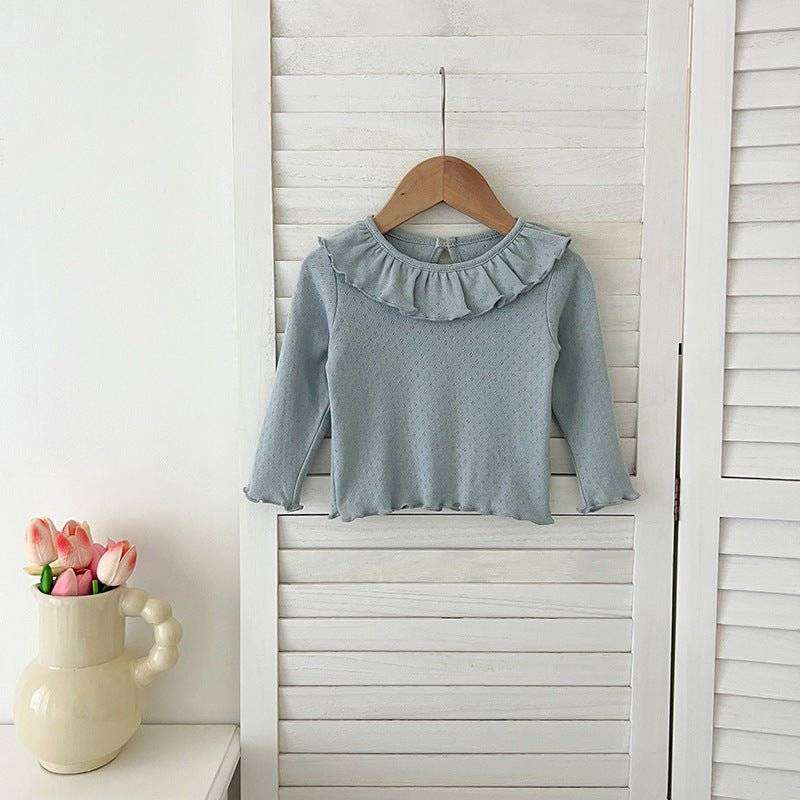 Girls soft comfortable long top with simple design hanging on a hanger.