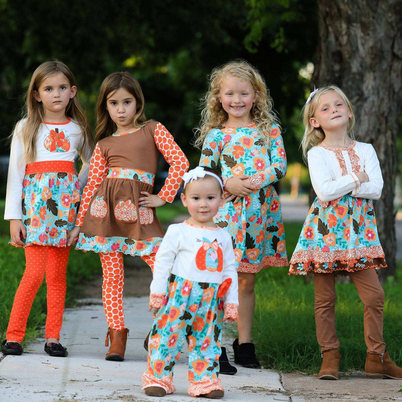 Girls Thanksgiving romper in autumn orange with pumpkin embroidery and fall floral prints.