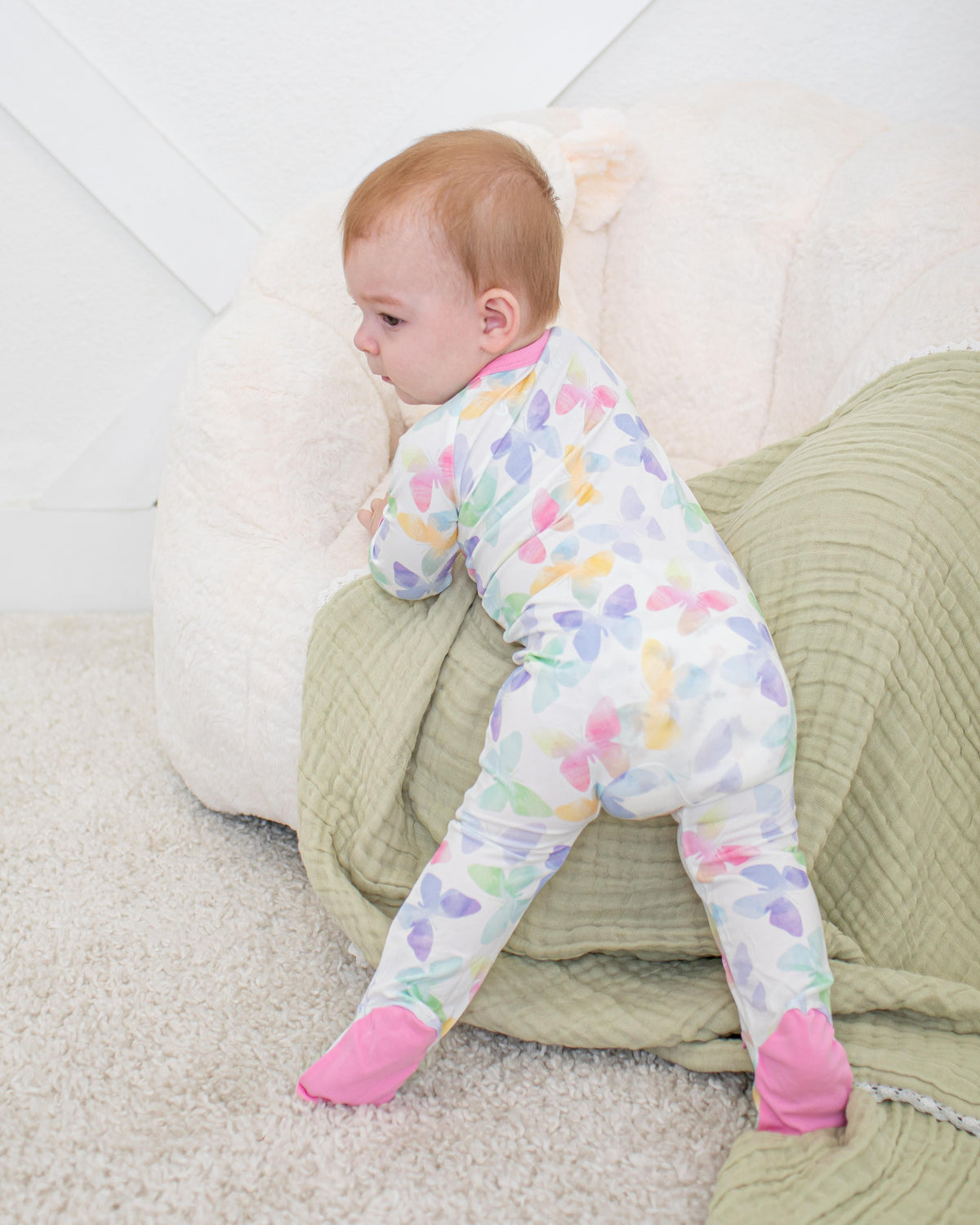 Baby footie pajamas in the Grace Wings print with a full-length two-way zipper and covered feet