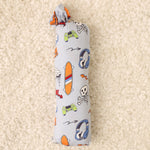 Swaddle blanket in a colorful graffiti print, spread flat to show the square shape.