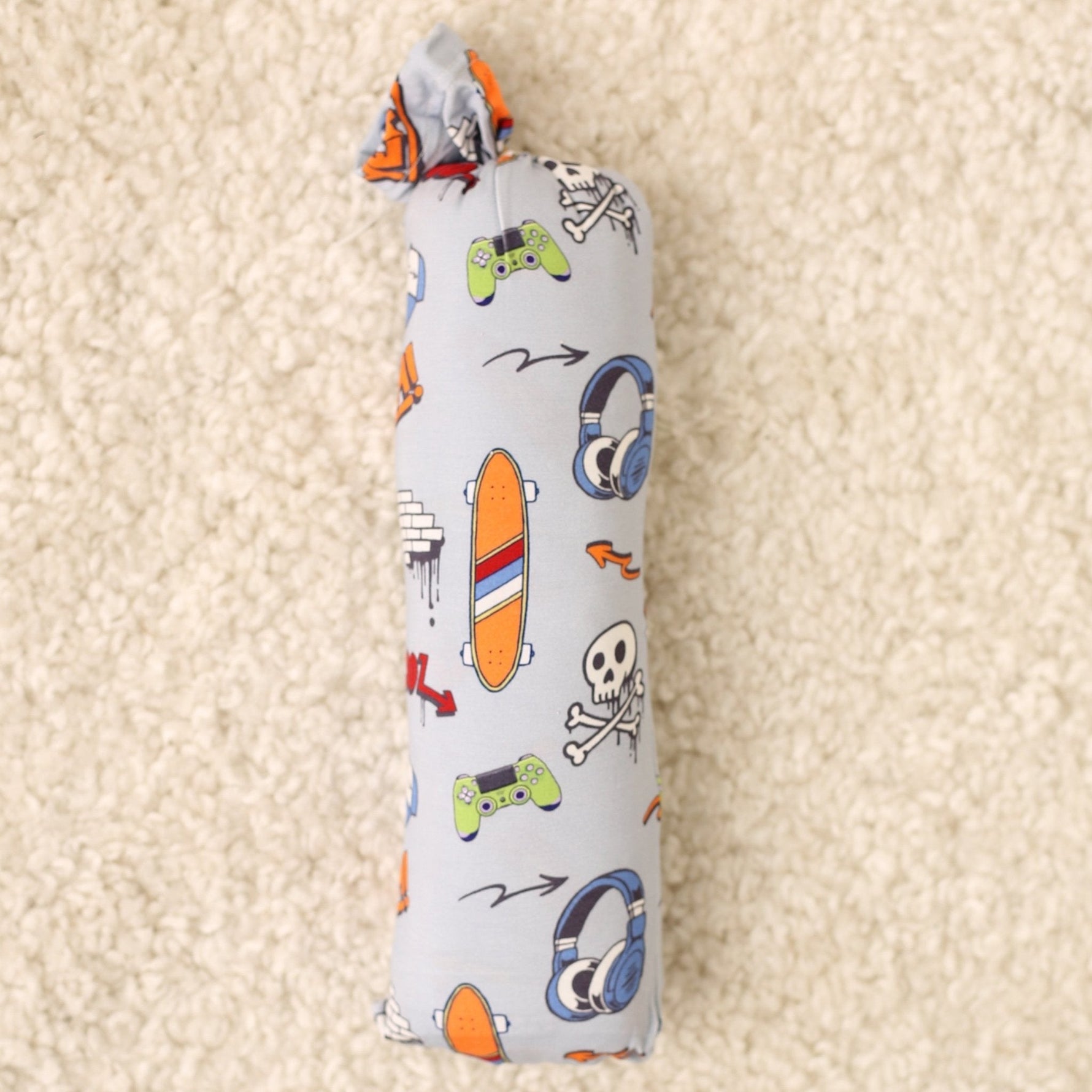 Swaddle blanket in a colorful graffiti print, spread flat to show the square shape.