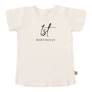 Charcoal graphic tee with a 1st birthday milestone print for a baby.