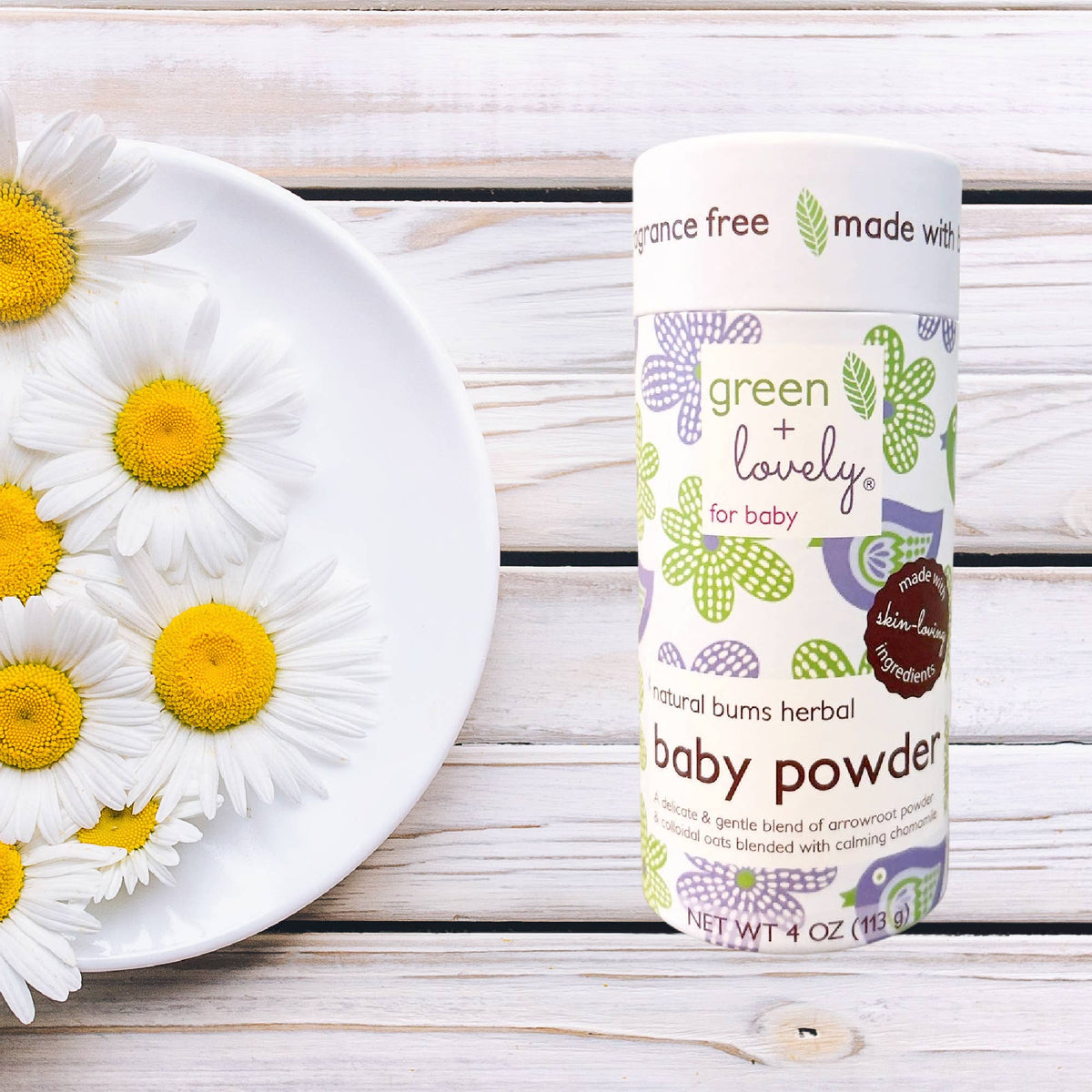 Green + Lovely Herbal Baby Powder with Soothing Oatmeal, shown in a natural, eco-friendly container.