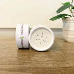 Green + Lovely Herbal Baby Powder with Soothing Oatmeal, shown in a natural, eco-friendly container.