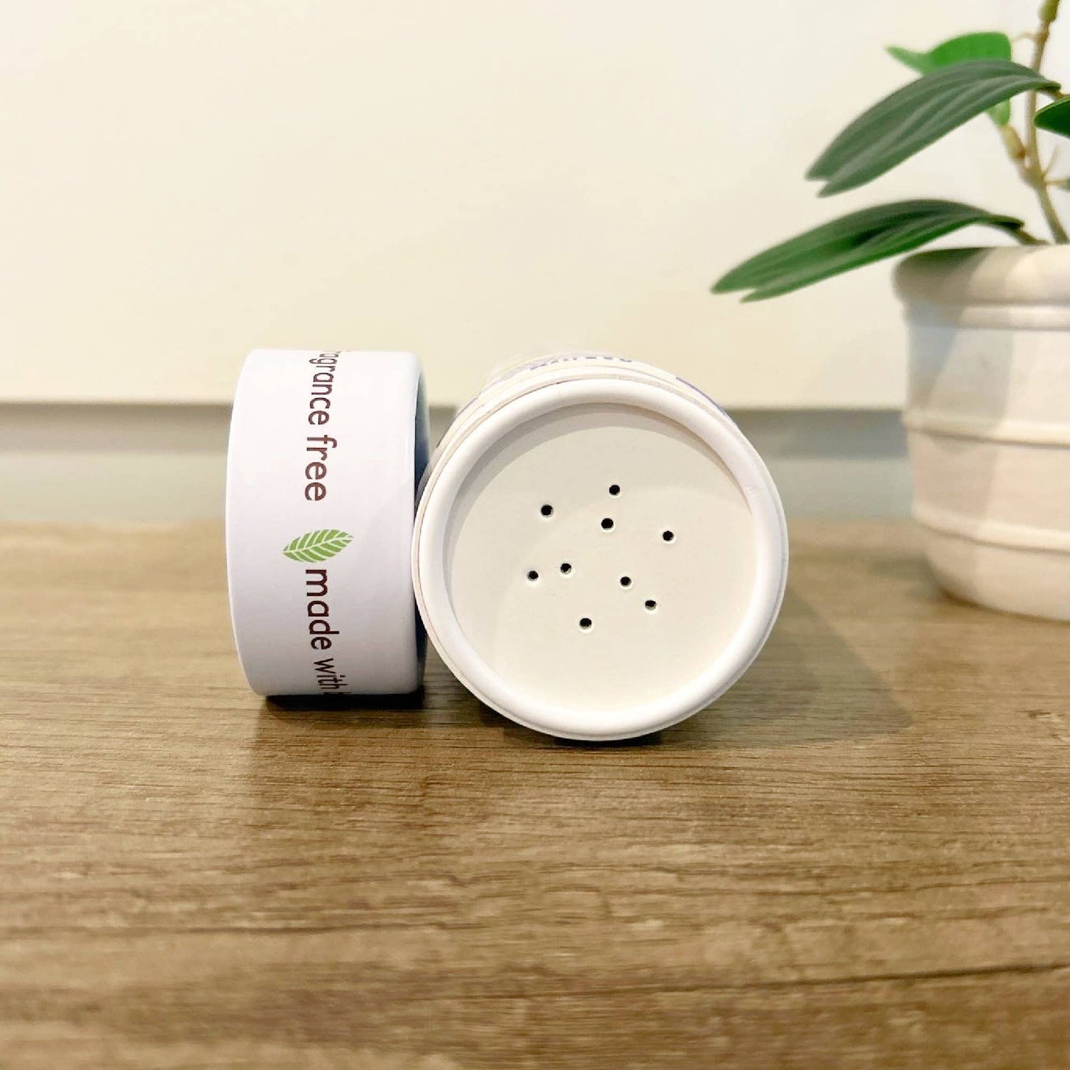 Green + Lovely Herbal Baby Powder with Soothing Oatmeal, shown in a natural, eco-friendly container.