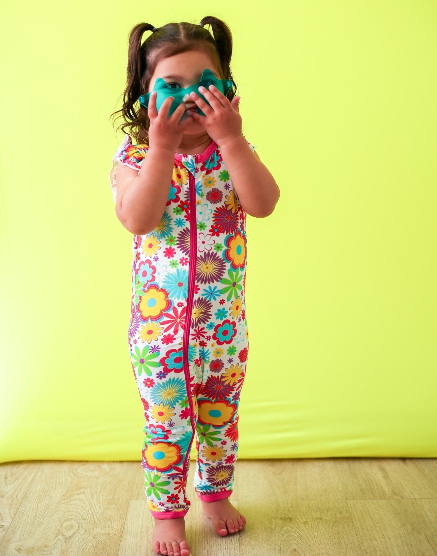 Floral flutter sleeve baby romper with dual zippers in a groovy bloom print