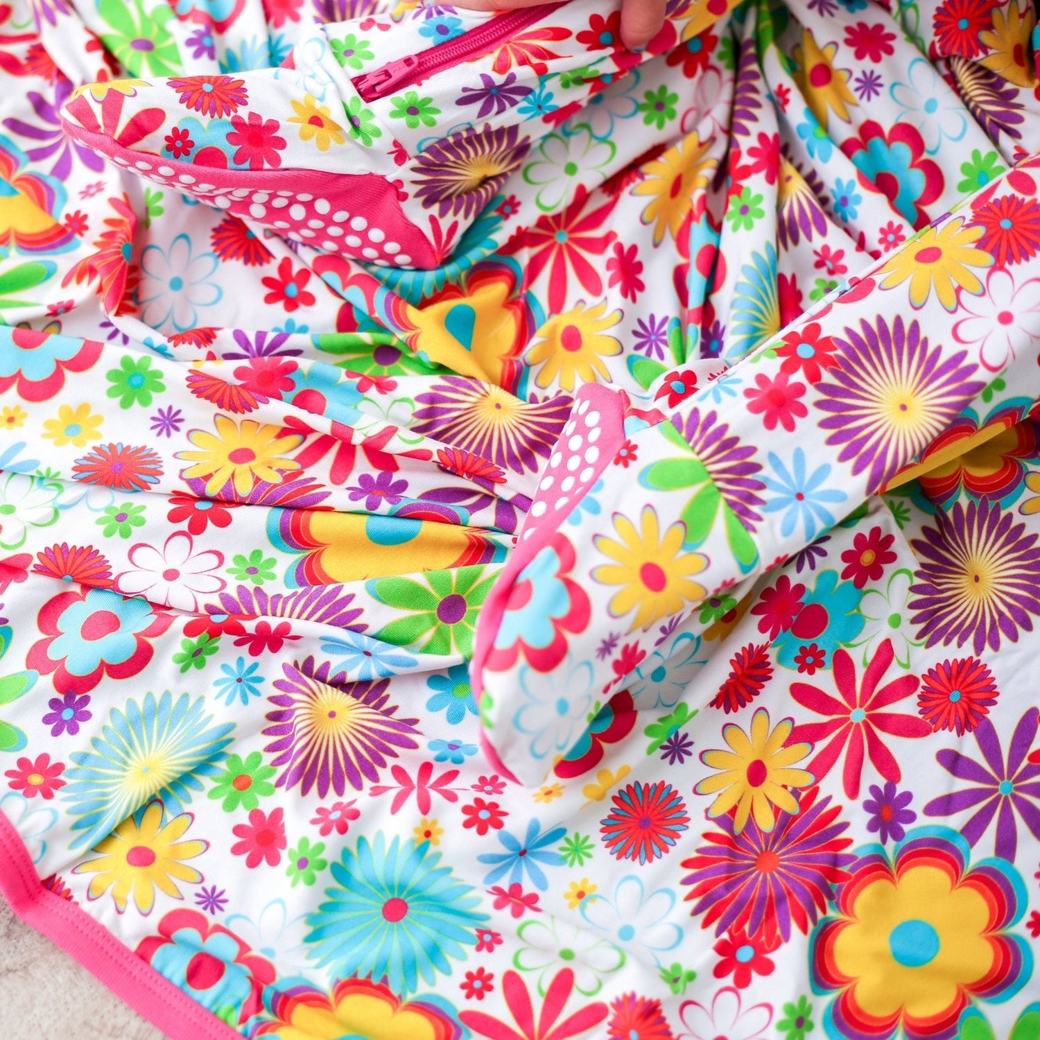 Square baby swaddle blanket with a retro pink and yellow floral bloom print