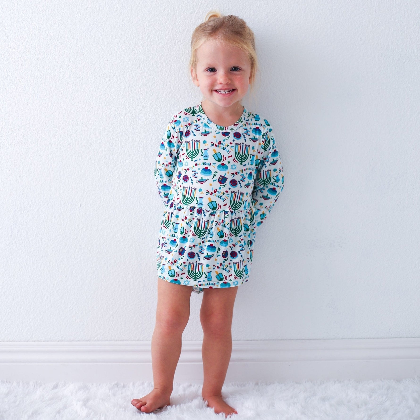 Long-sleeve bodysuit dress with a Hanukkah-themed print and snap closure at the inseam